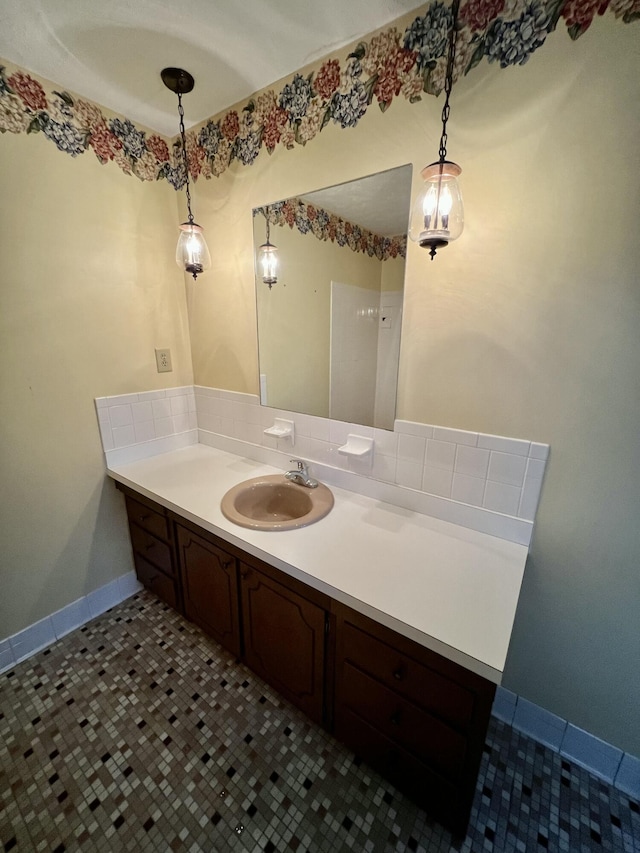 bathroom with tile patterned floors, baseboards, and vanity