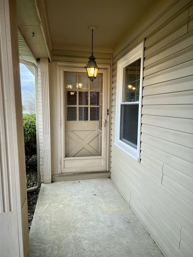 view of exterior entry featuring a porch