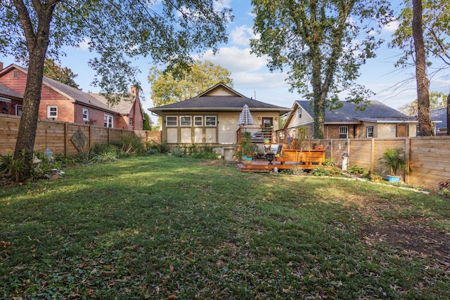 back of house featuring a yard and a deck