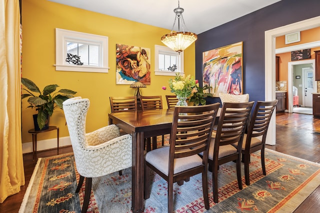 dining room featuring a notable chandelier and dark hardwood / wood-style floors