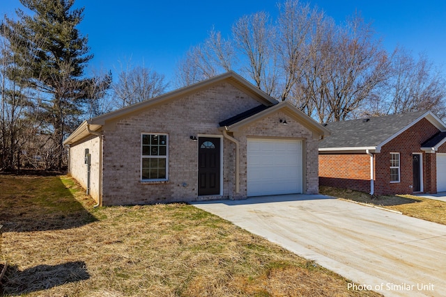 313 Baughman Ave Unit 25, Danville, KY 40422 - view of front of house with a front yard, concrete driveway, a garage, and brick siding