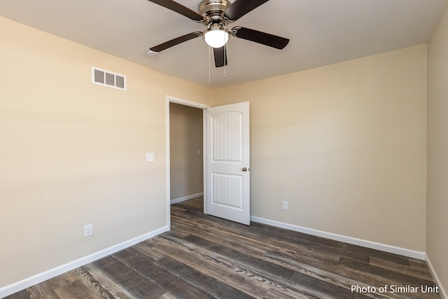 spare room with ceiling fan and dark hardwood / wood-style flooring