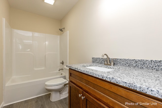 full bathroom with bathing tub / shower combination, vanity, a textured ceiling, wood-type flooring, and toilet