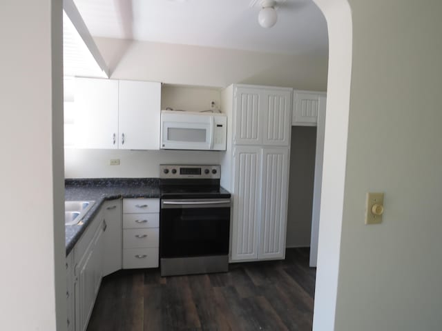 kitchen featuring white cabinetry, stainless steel electric range, dark wood-style flooring, and white microwave