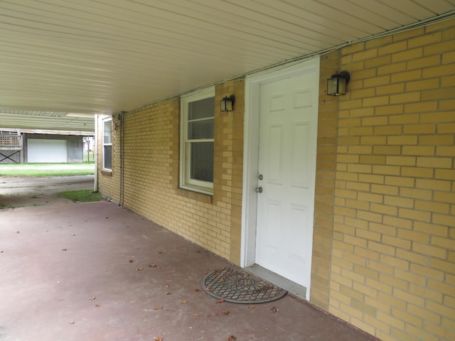 property entrance featuring brick siding