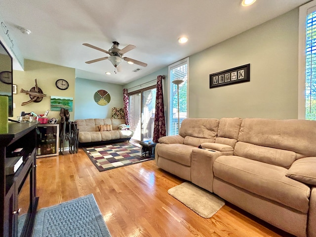 living room featuring ceiling fan and light wood-type flooring