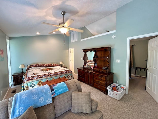 carpeted bedroom featuring lofted ceiling, a textured ceiling, and ceiling fan