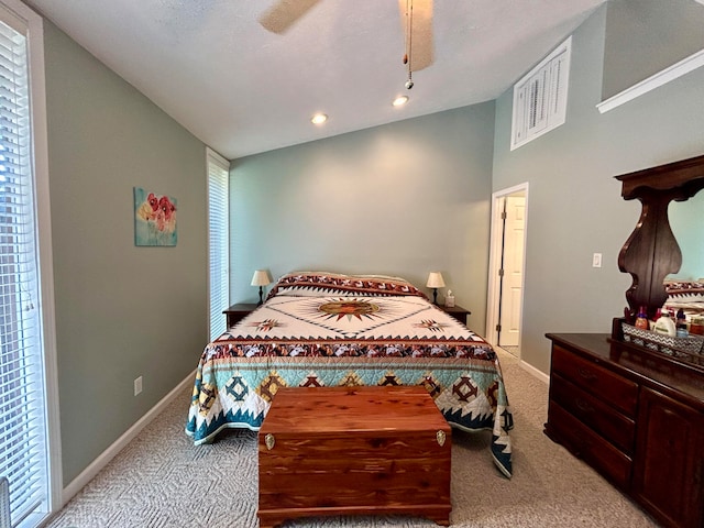 bedroom with light colored carpet, vaulted ceiling, and ceiling fan