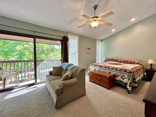 carpeted bedroom with a textured ceiling, ceiling fan, and access to outside