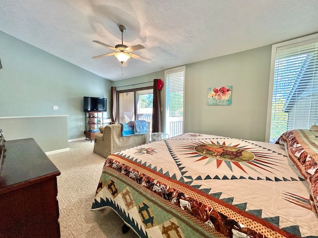 carpeted bedroom with lofted ceiling, ceiling fan, and a textured ceiling