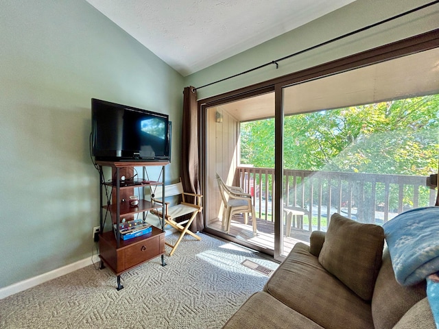 living room with carpet floors and vaulted ceiling