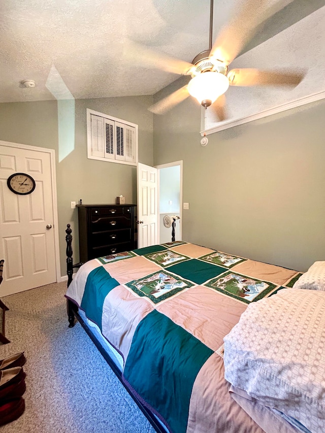 carpeted bedroom with lofted ceiling, a textured ceiling, and ceiling fan