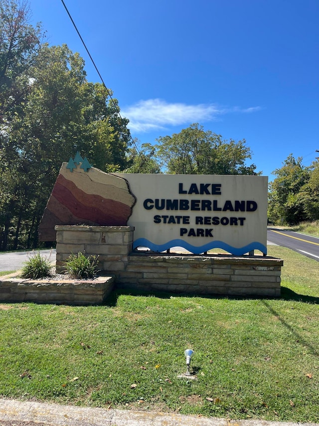 community / neighborhood sign with a lawn