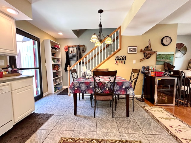 dining space with built in features, an inviting chandelier, and light tile patterned floors