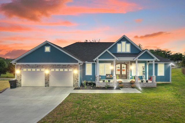 craftsman inspired home featuring a yard, a porch, and a garage