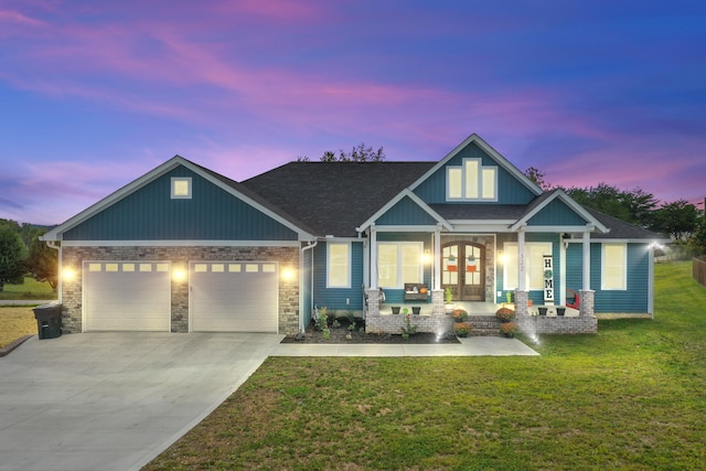 craftsman-style house with a porch, a garage, and a yard