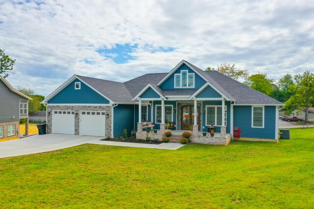 craftsman-style home featuring a front yard, a porch, a garage, and central air condition unit