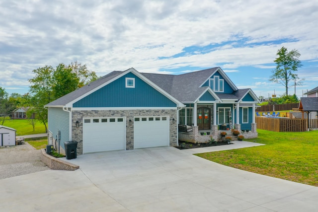 craftsman house featuring a front lawn and a garage