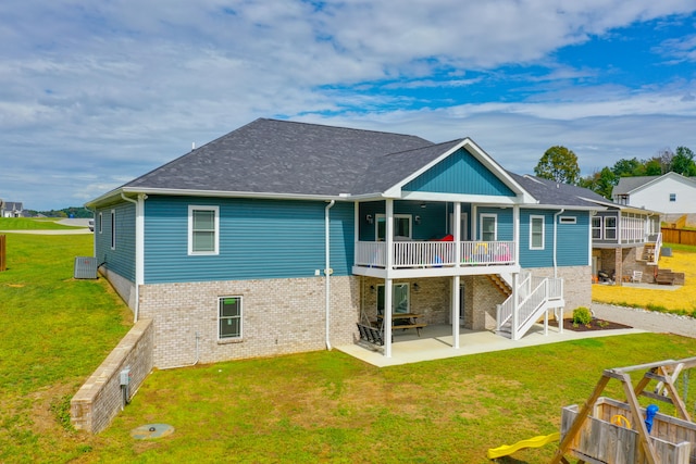 back of property featuring central AC unit, a yard, a patio, and a wooden deck