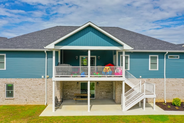 rear view of property with a lawn and a patio