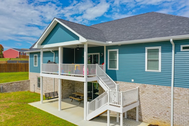 back of property featuring a lawn, ceiling fan, and a patio