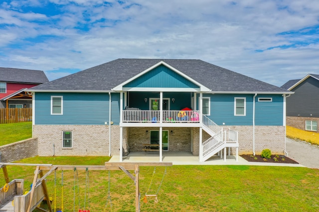 rear view of house with a lawn and a patio area