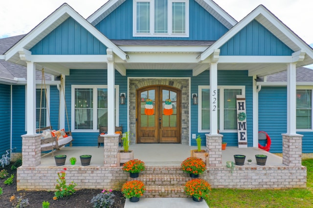 doorway to property with covered porch and french doors