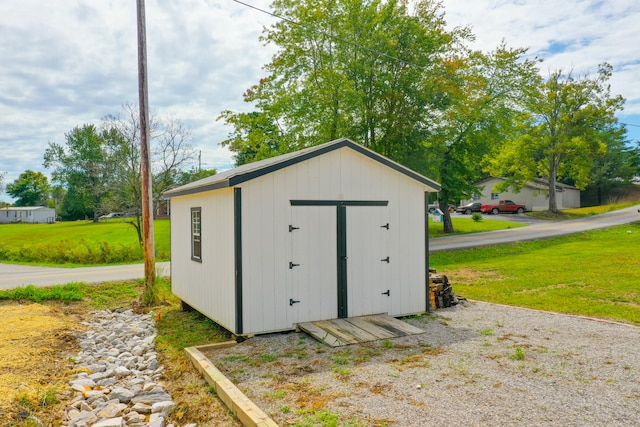 view of outbuilding featuring a lawn