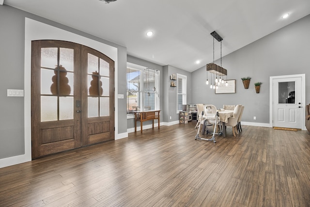 foyer with lofted ceiling, french doors, and dark hardwood / wood-style floors