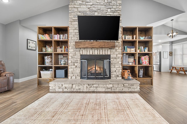 living room featuring a fireplace, wood-type flooring, and lofted ceiling