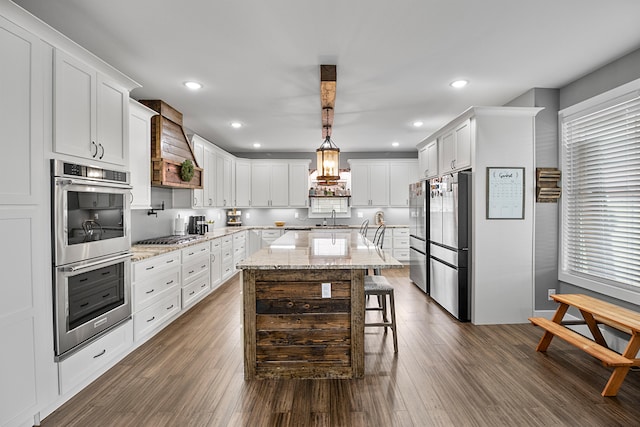 kitchen featuring pendant lighting, dark hardwood / wood-style flooring, custom range hood, and sink