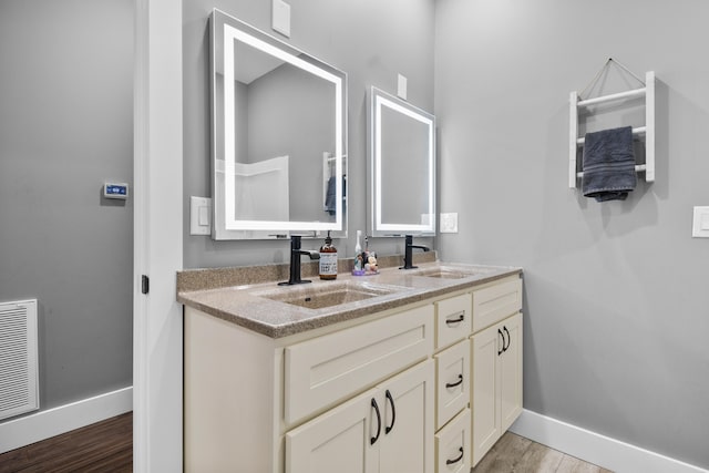 bathroom with hardwood / wood-style flooring and vanity