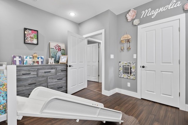 bedroom with dark wood-type flooring