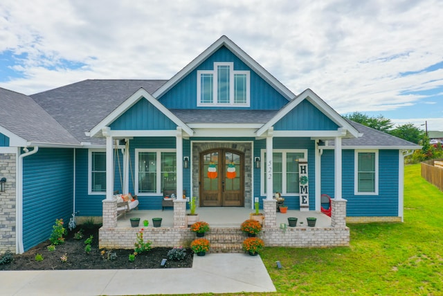 craftsman inspired home with covered porch and a front lawn