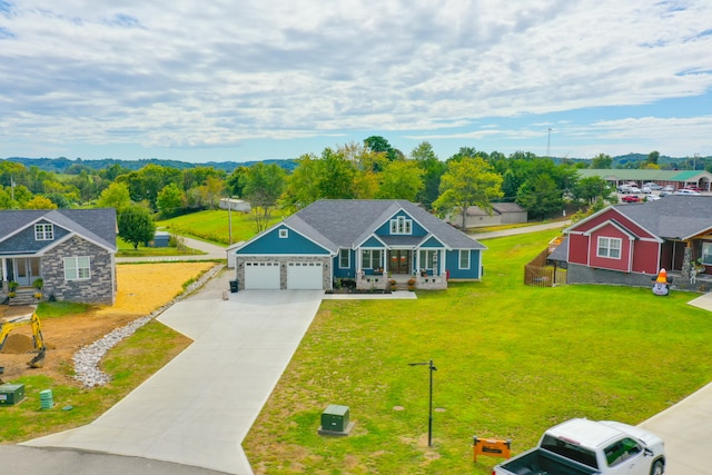 view of front of home featuring a front yard, a porch, and a garage