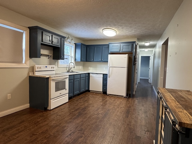 kitchen with white appliances, sink, dark hardwood / wood-style floors, a textured ceiling, and butcher block countertops