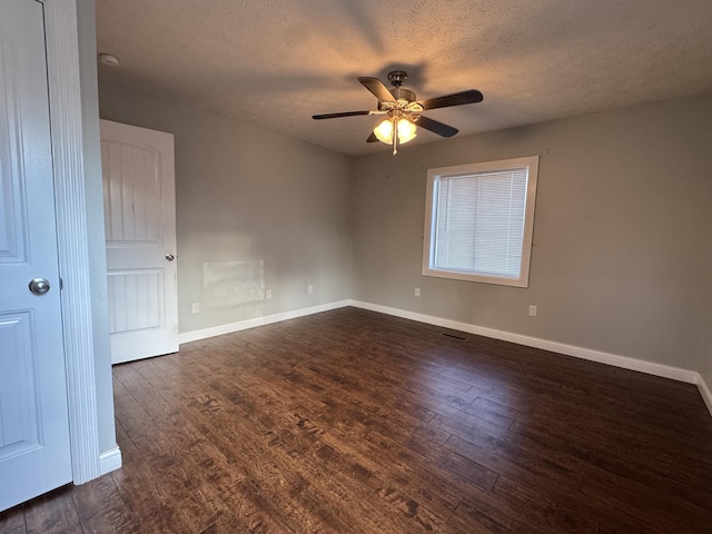 unfurnished room featuring ceiling fan, dark hardwood / wood-style flooring, and a textured ceiling