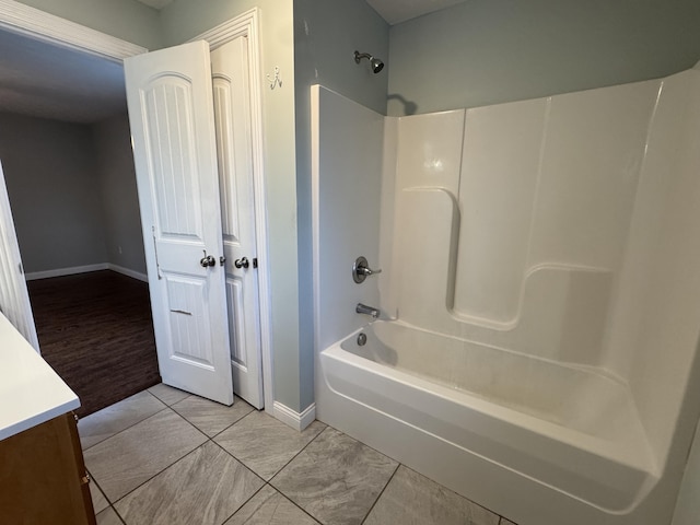 bathroom featuring tile patterned flooring, vanity, and shower / washtub combination