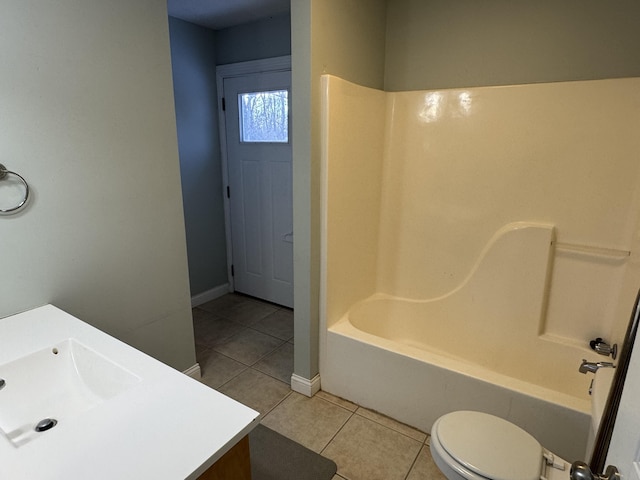 full bathroom featuring toilet, vanity, tile patterned floors, and tub / shower combination