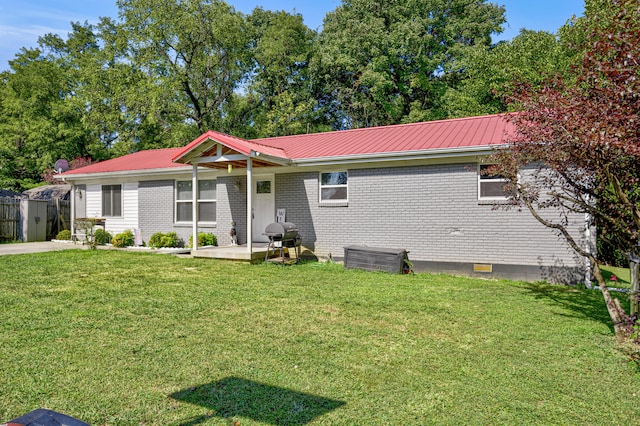 view of front of property with a front yard and a patio