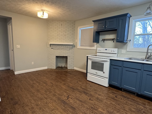 kitchen featuring blue cabinetry, sink, a fireplace, and white electric range