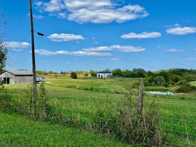 view of yard featuring a rural view and a water view