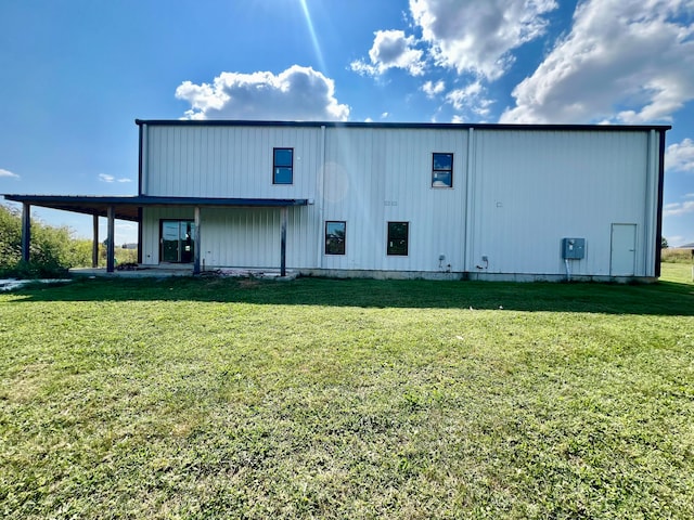 rear view of property with a lawn