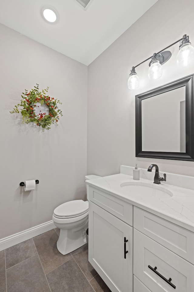 bathroom with vanity, toilet, and tile patterned floors