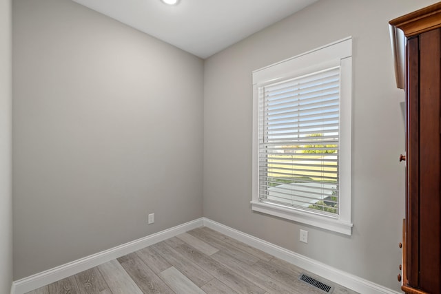 empty room with light hardwood / wood-style flooring