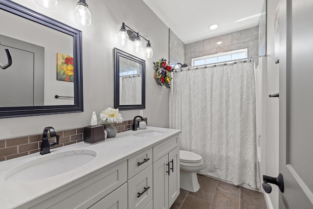 full bathroom with vanity, tile patterned flooring, shower / tub combo, toilet, and decorative backsplash