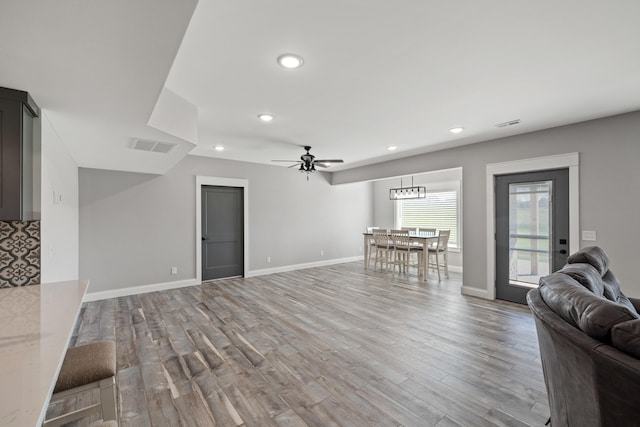 living room with ceiling fan and hardwood / wood-style flooring