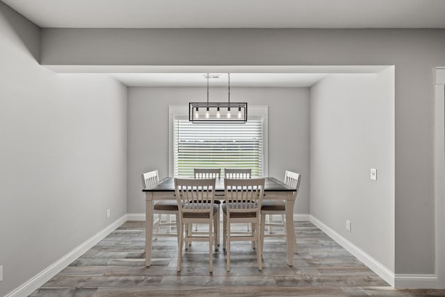 unfurnished dining area featuring wood-type flooring