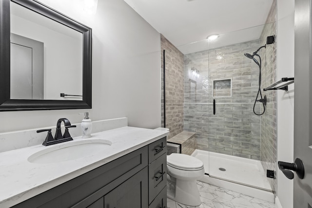 bathroom featuring vanity, toilet, and an enclosed shower