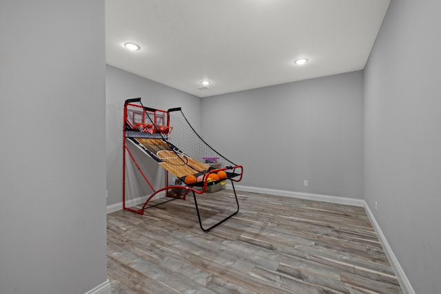 game room with light wood-type flooring